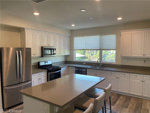 kitchen featuring white cabinets, stainless steel appliances, and a sink
