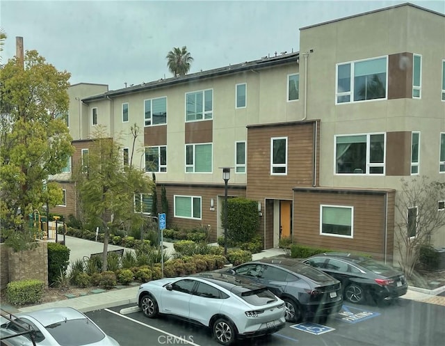 view of building exterior featuring uncovered parking