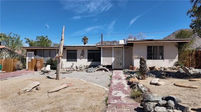 single story home featuring fence and stucco siding