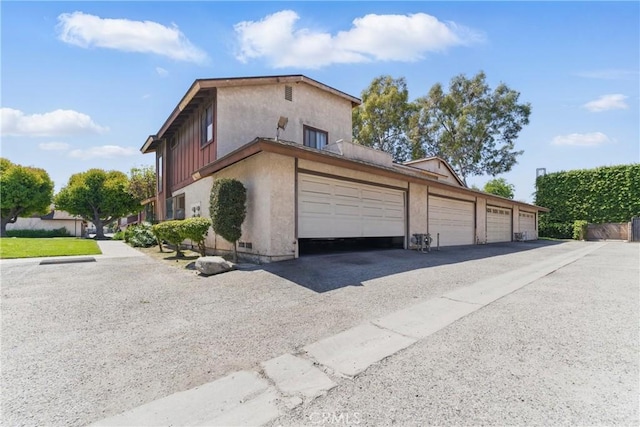 8028 Harrison St, Paramount, CA 90723 - view of side of property with stucco siding and aphalt driveway
