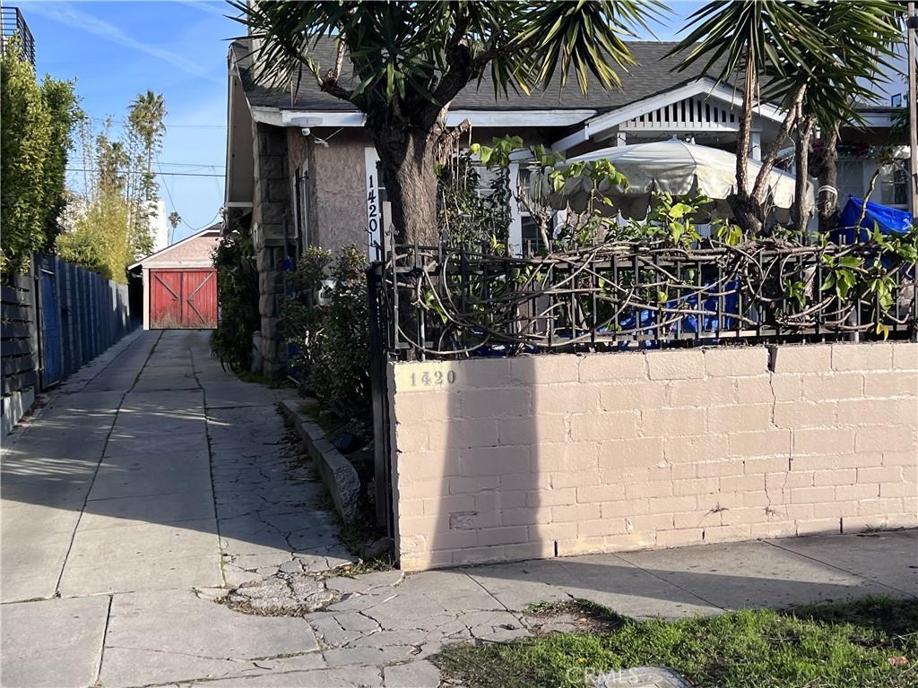 view of gate featuring an outdoor structure and fence