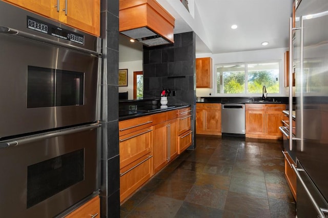 27509 Mountain Meadow Rd, Escondido, CA 92026 - kitchen featuring stainless steel appliances, a sink, recessed lighting, brown cabinetry, and dark countertops