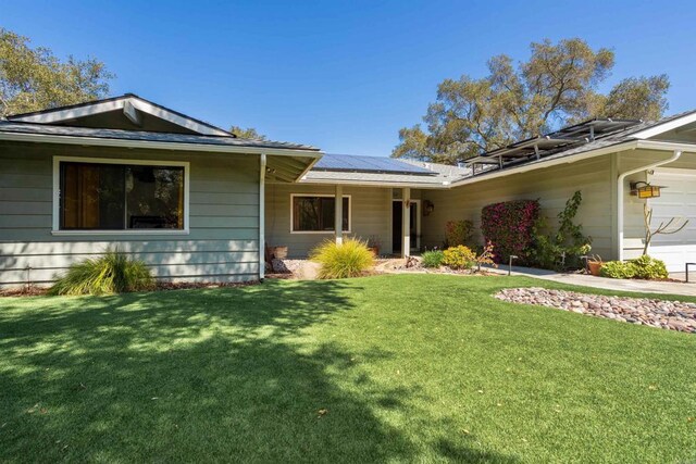 27509 Mountain Meadow Rd, Escondido, CA 92026 - view of front facade featuring roof mounted solar panels, a front yard, and a garage