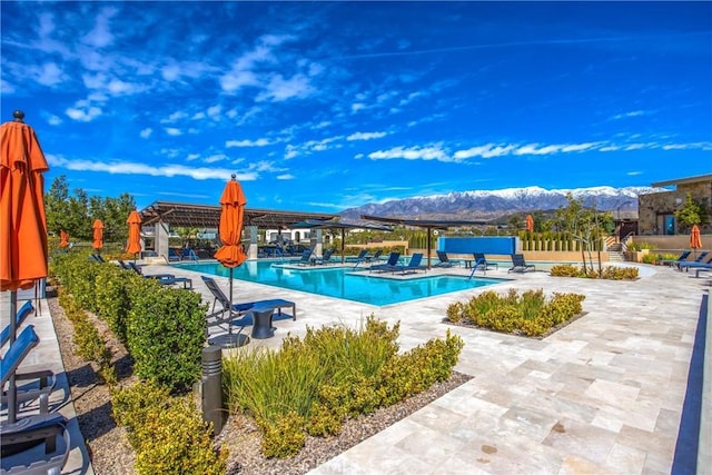pool featuring a pergola, a patio area, and a mountain view