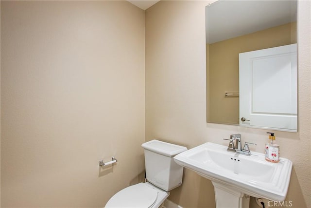 half bathroom with a sink and toilet