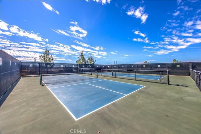 view of tennis court with fence