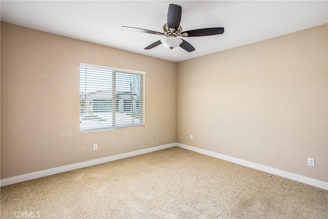 spare room featuring carpet, baseboards, and ceiling fan