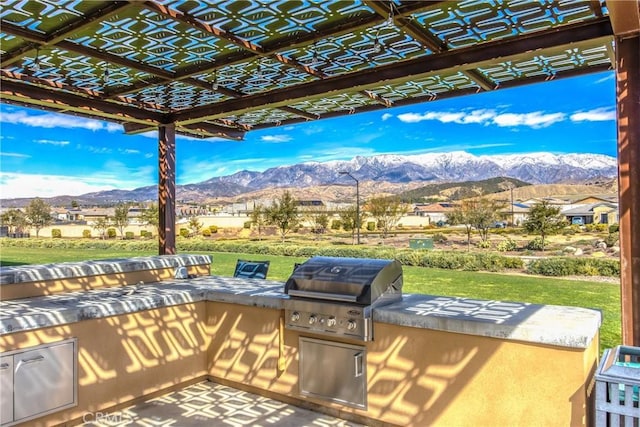 view of patio / terrace with a mountain view, grilling area, area for grilling, and a pergola