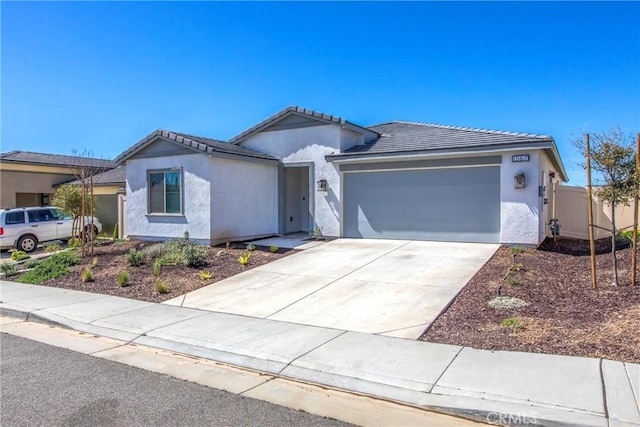 single story home with a tiled roof, a garage, stucco siding, and concrete driveway
