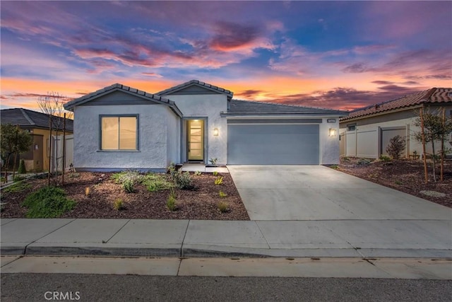 ranch-style house featuring concrete driveway, stucco siding, a tiled roof, and an attached garage