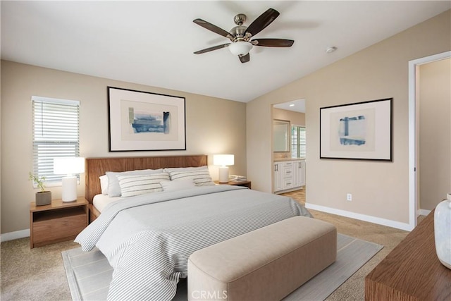 bedroom featuring multiple windows, light colored carpet, baseboards, and lofted ceiling