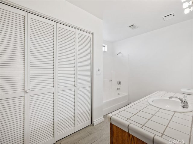 19246 Pine Way, Apple Valley, CA 92308 - bathroom with a closet, vanity, and tub / shower combination