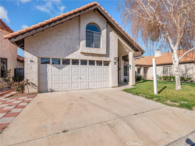 19246 Pine Way, Apple Valley, CA 92308 - view of front of house with driveway, a front yard, stucco siding, and a tile roof