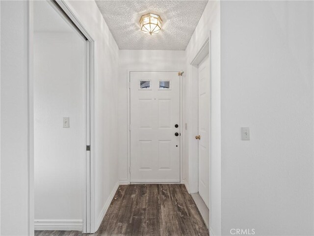 19246 Pine Way, Apple Valley, CA 92308 - doorway to outside featuring a textured ceiling, dark wood-style floors, and baseboards