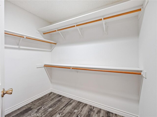 19246 Pine Way, Apple Valley, CA 92308 - spacious closet featuring dark wood-style floors