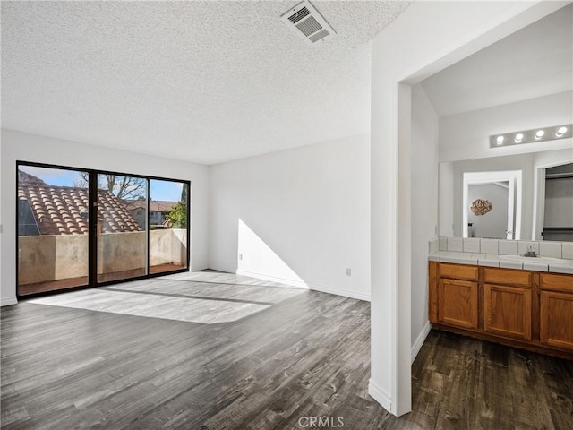 19246 Pine Way, Apple Valley, CA 92308 - unfurnished room featuring dark wood-style floors, a textured ceiling, baseboards, and a sink
