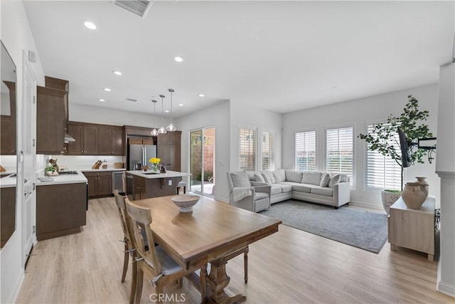 dining room with recessed lighting, light wood-style floors, and visible vents
