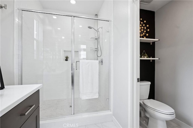full bath featuring a shower stall, marble finish floor, and toilet
