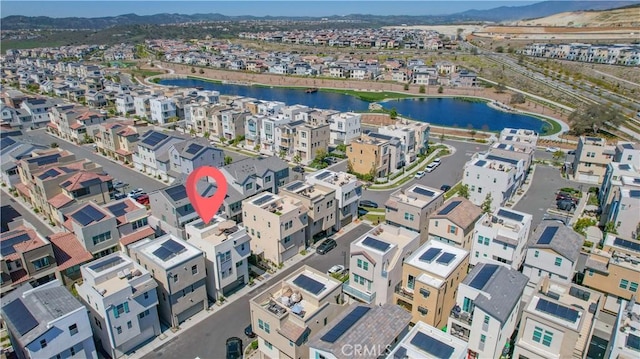 aerial view featuring a residential view and a water view