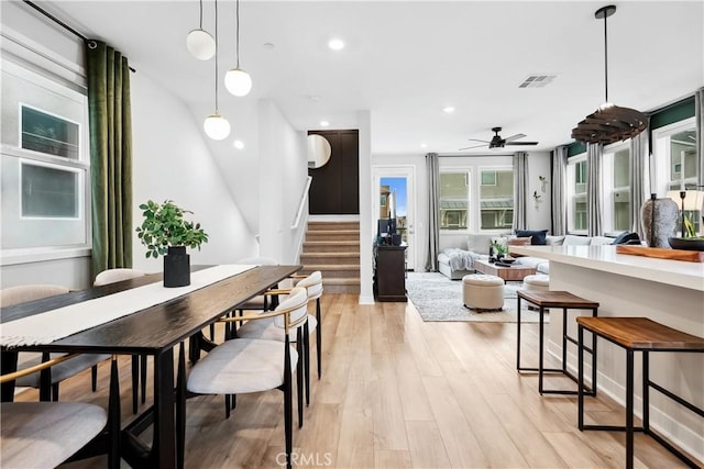 dining room with stairs, a ceiling fan, light wood finished floors, visible vents, and recessed lighting