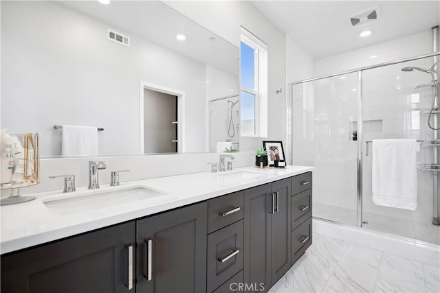 bathroom featuring a stall shower, visible vents, and a sink