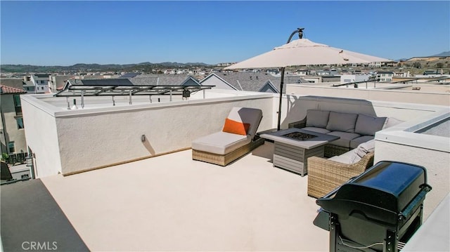 view of patio featuring a balcony and an outdoor living space with a fire pit