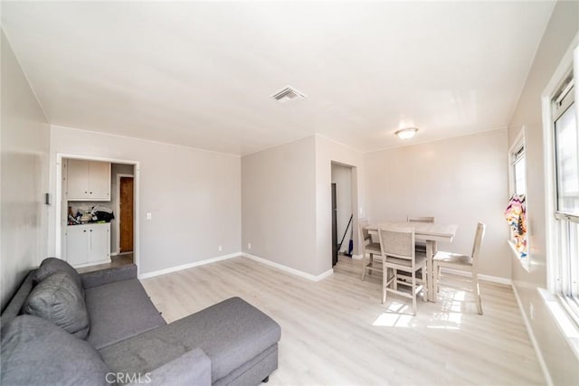 541 Elm Ave, Inglewood, CA 90301 - living room with visible vents, light wood-style flooring, and baseboards