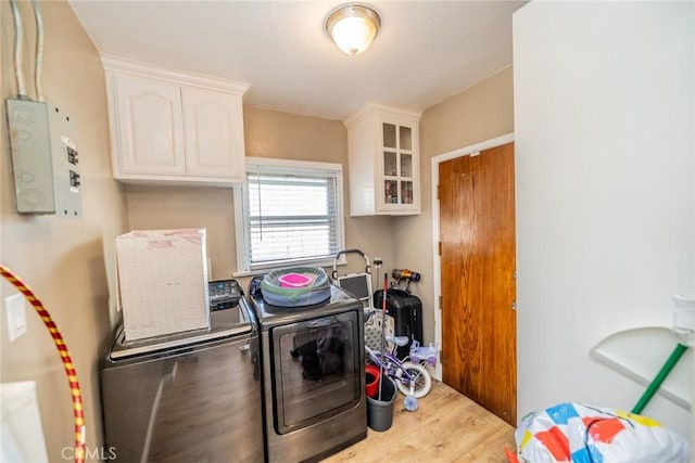 541 Elm Ave, Inglewood, CA 90301 - laundry room featuring cabinet space, washing machine and dryer, and light wood finished floors