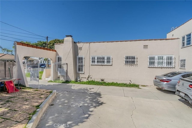 541 Elm Ave, Inglewood, CA 90301 - exterior space with stucco siding, a gate, a trampoline, fence, and crawl space