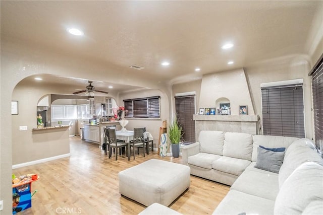 541 Elm Ave, Inglewood, CA 90301 - living room featuring visible vents, light wood-style flooring, recessed lighting, arched walkways, and ceiling fan
