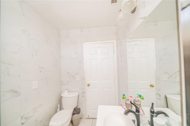 541 Elm Ave, Inglewood, CA 90301 - half bath with tile walls, marble finish floor, toilet, and vanity