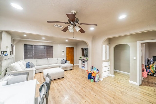 541 Elm Ave, Inglewood, CA 90301 - living room with visible vents, light wood-type flooring, recessed lighting, arched walkways, and a ceiling fan
