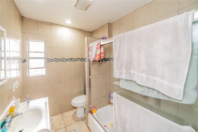 541 Elm Ave, Inglewood, CA 90301 - bathroom with enclosed tub / shower combo, a sink, tile walls, toilet, and tile patterned floors