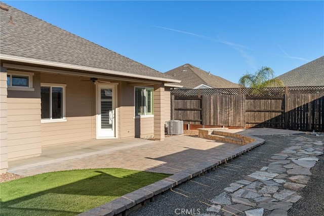 view of patio / terrace featuring ceiling fan, a fenced backyard, and cooling unit