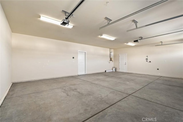 garage featuring a garage door opener and baseboards