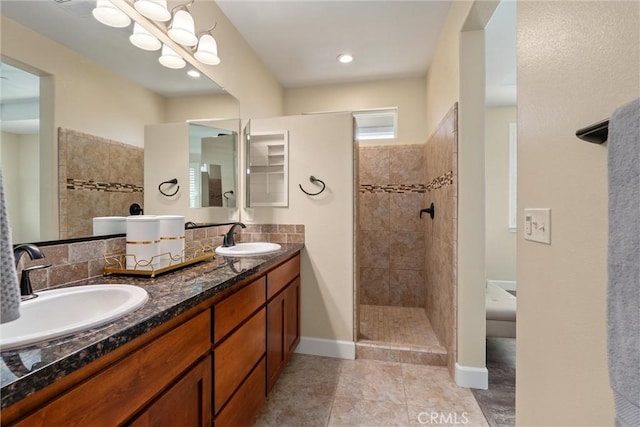 bathroom with tile patterned floors, walk in shower, a sink, and double vanity