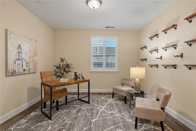 home office featuring baseboards, wood finished floors, and visible vents