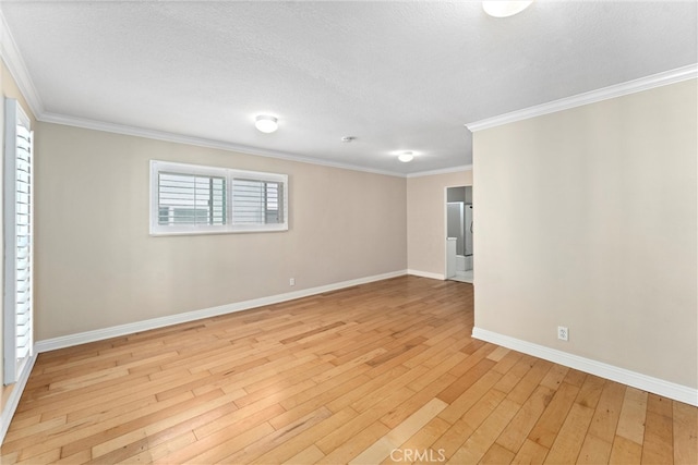 unfurnished room featuring crown molding, baseboards, light wood-type flooring, and a textured ceiling