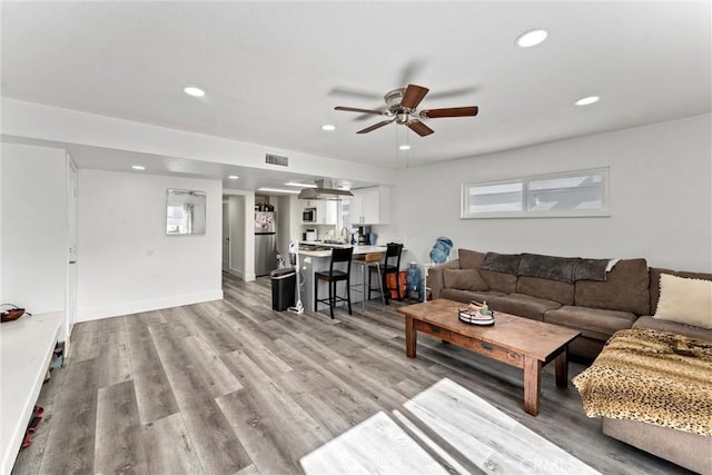 living room featuring recessed lighting, visible vents, light wood finished floors, and ceiling fan