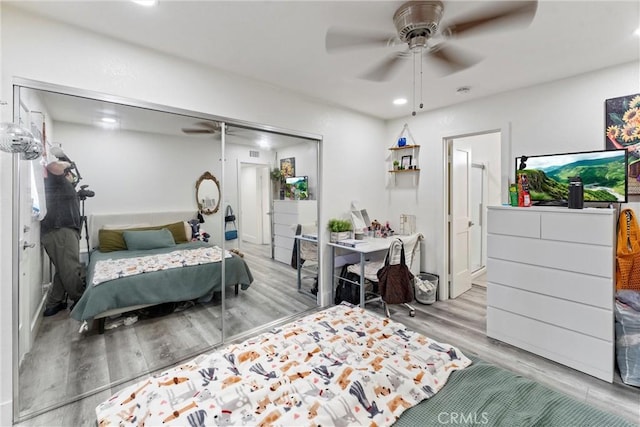 bedroom with a closet, recessed lighting, a ceiling fan, and wood finished floors