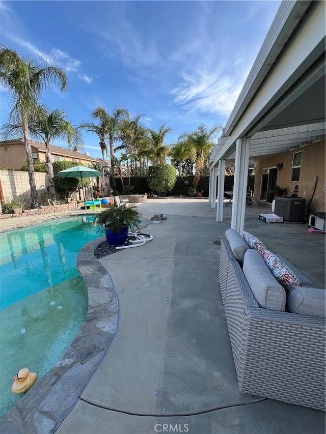 view of pool featuring a fenced backyard, a fenced in pool, an outdoor hangout area, and a patio area