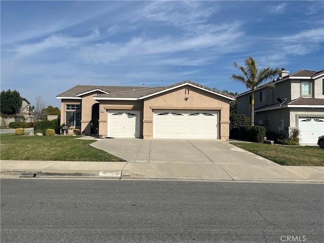 view of front of house featuring stucco siding, a garage, a front lawn, and concrete driveway