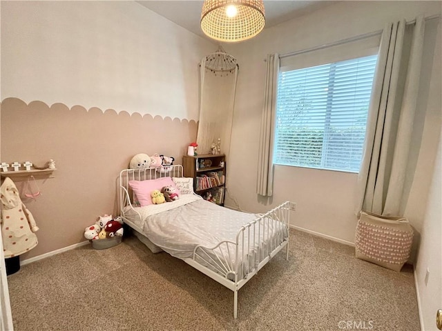 bedroom featuring baseboards and carpet