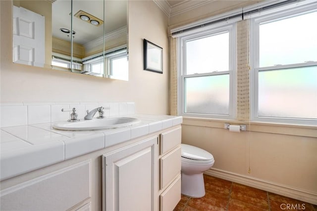 bathroom featuring toilet, vanity, and ornamental molding