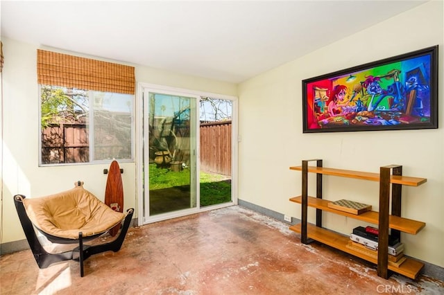 entryway with concrete floors and baseboards