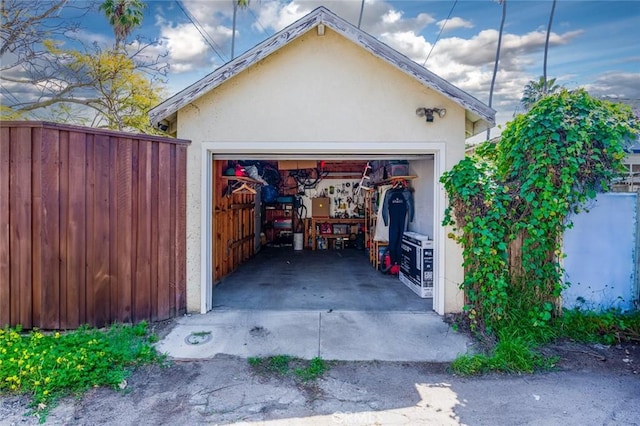detached garage featuring fence