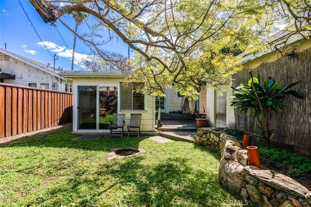back of house with fence and a yard