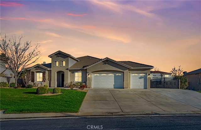 view of front of property featuring stucco siding, a garage, a tile roof, a front yard, and concrete driveway