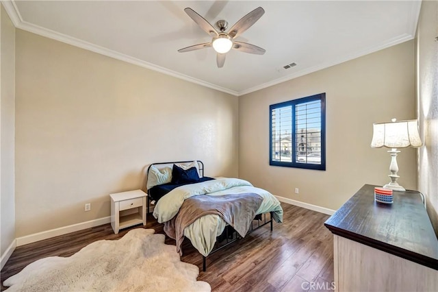 bedroom featuring baseboards, ceiling fan, dark wood-style flooring, and crown molding