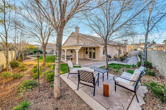 exterior space with french doors and a fenced backyard